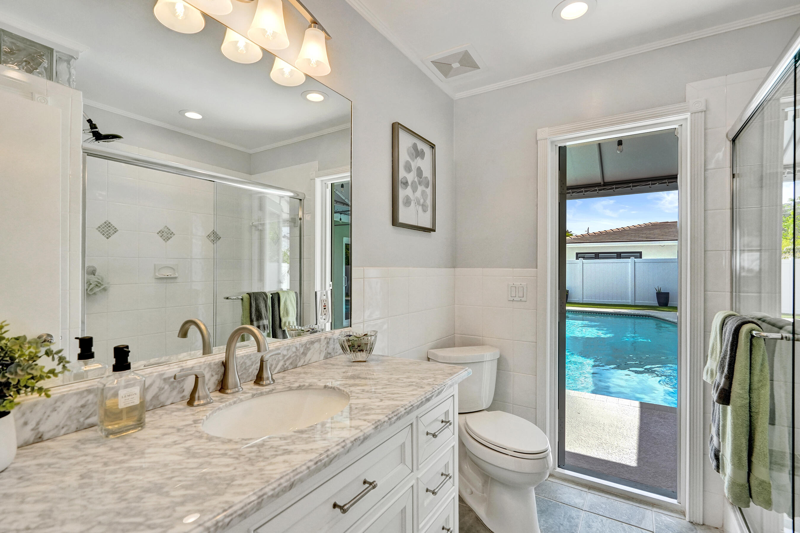 3001 Northeast 45th Street Lighthouse Point, FL 33064 - Photo 43 of 67 a bathroom with a granite countertop sink toilet and shower