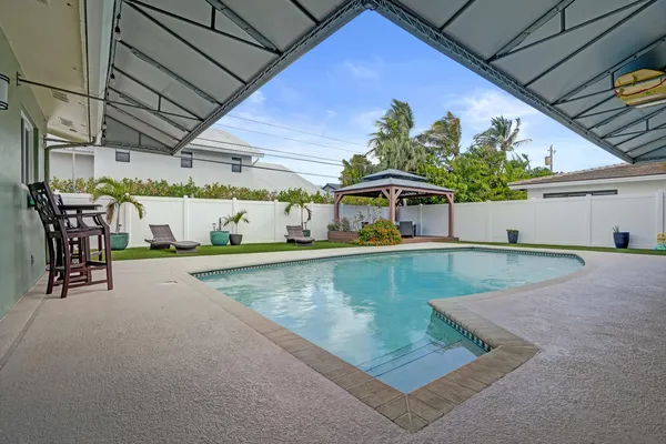 a view of a backyard with plants and a patio