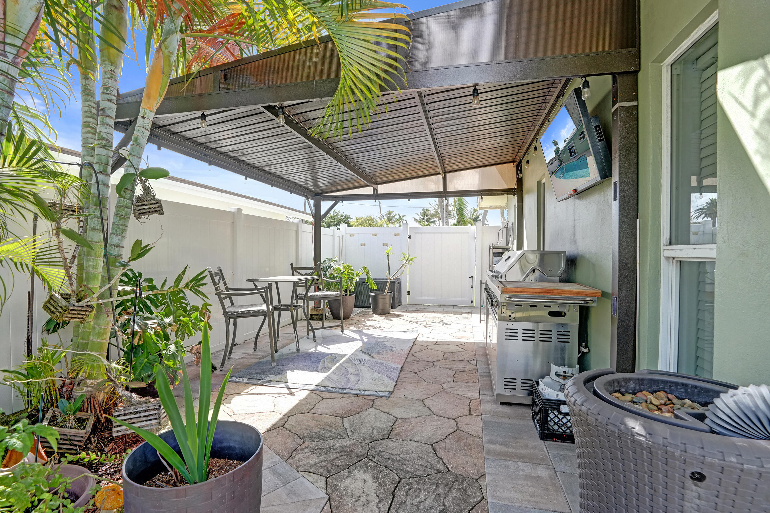 3001 Northeast 45th Street Lighthouse Point, FL 33064 - Photo 49 of 67 a patio with glass top table and chairs