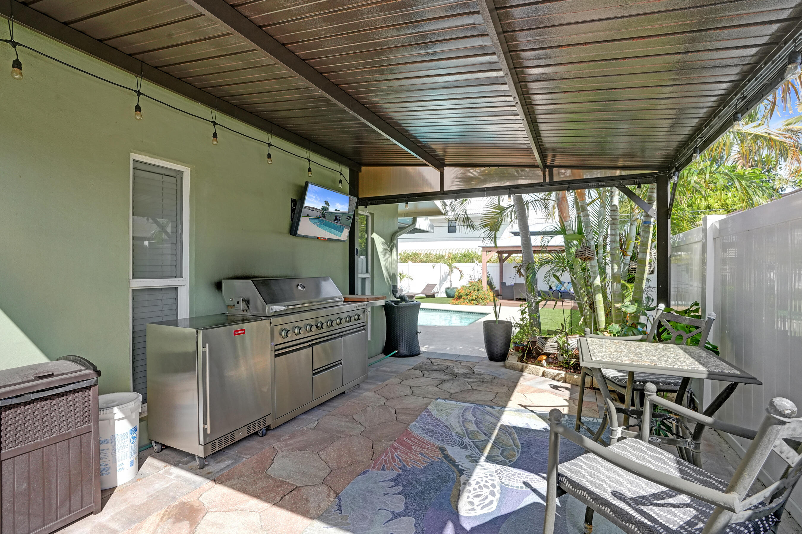 3001 Northeast 45th Street Lighthouse Point, FL 33064 - Photo 51 of 67 a kitchen with stainless steel appliances granite countertop a barbecue grill and a wooden cabinets