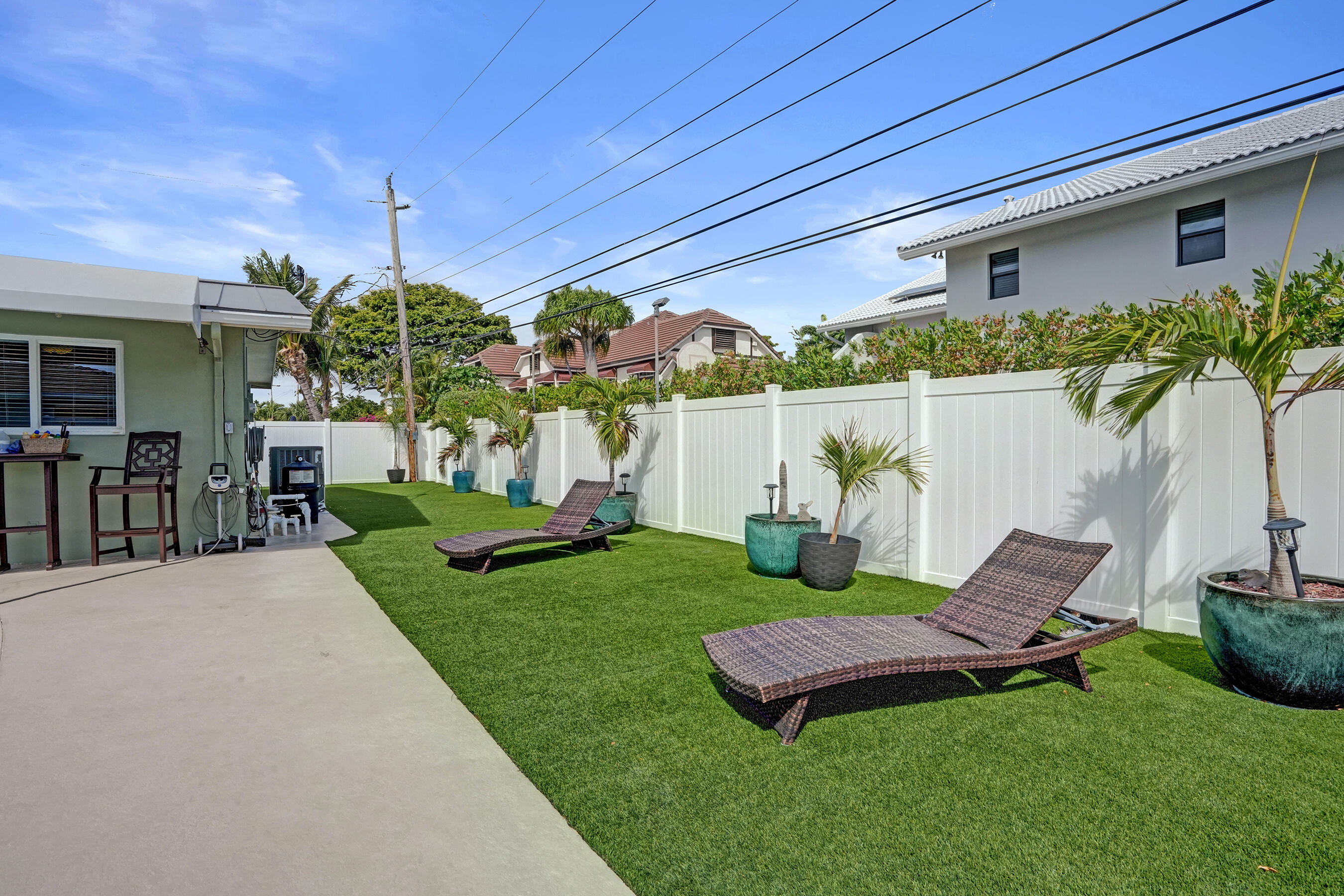 3001 Northeast 45th Street Lighthouse Point, FL 33064 - Photo 60 of 67 a view of a backyard with plants and a patio