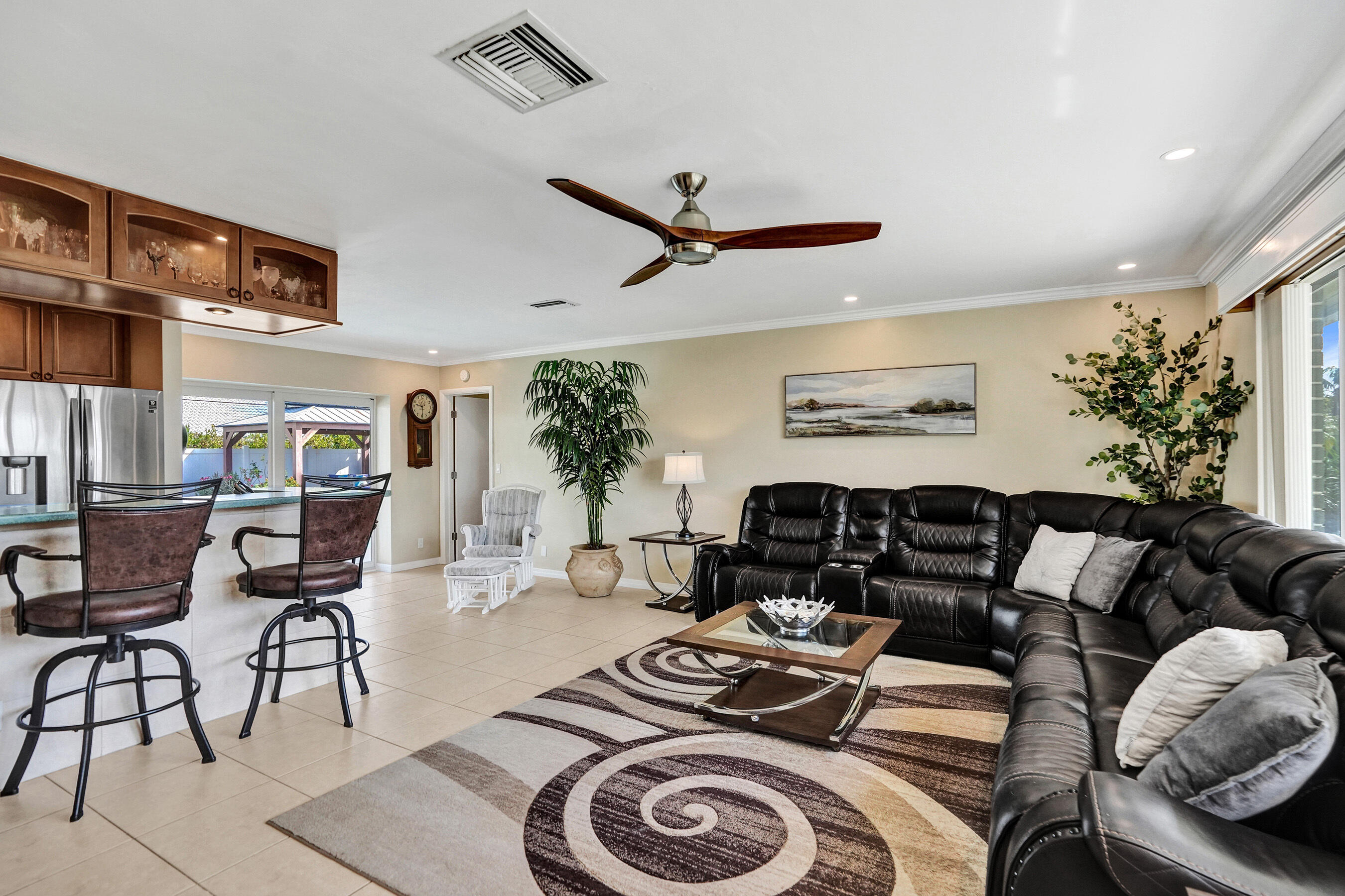 3001 Northeast 45th Street Lighthouse Point, FL 33064 - Photo 6 of 67 a living room with furniture a rug and a chandelier