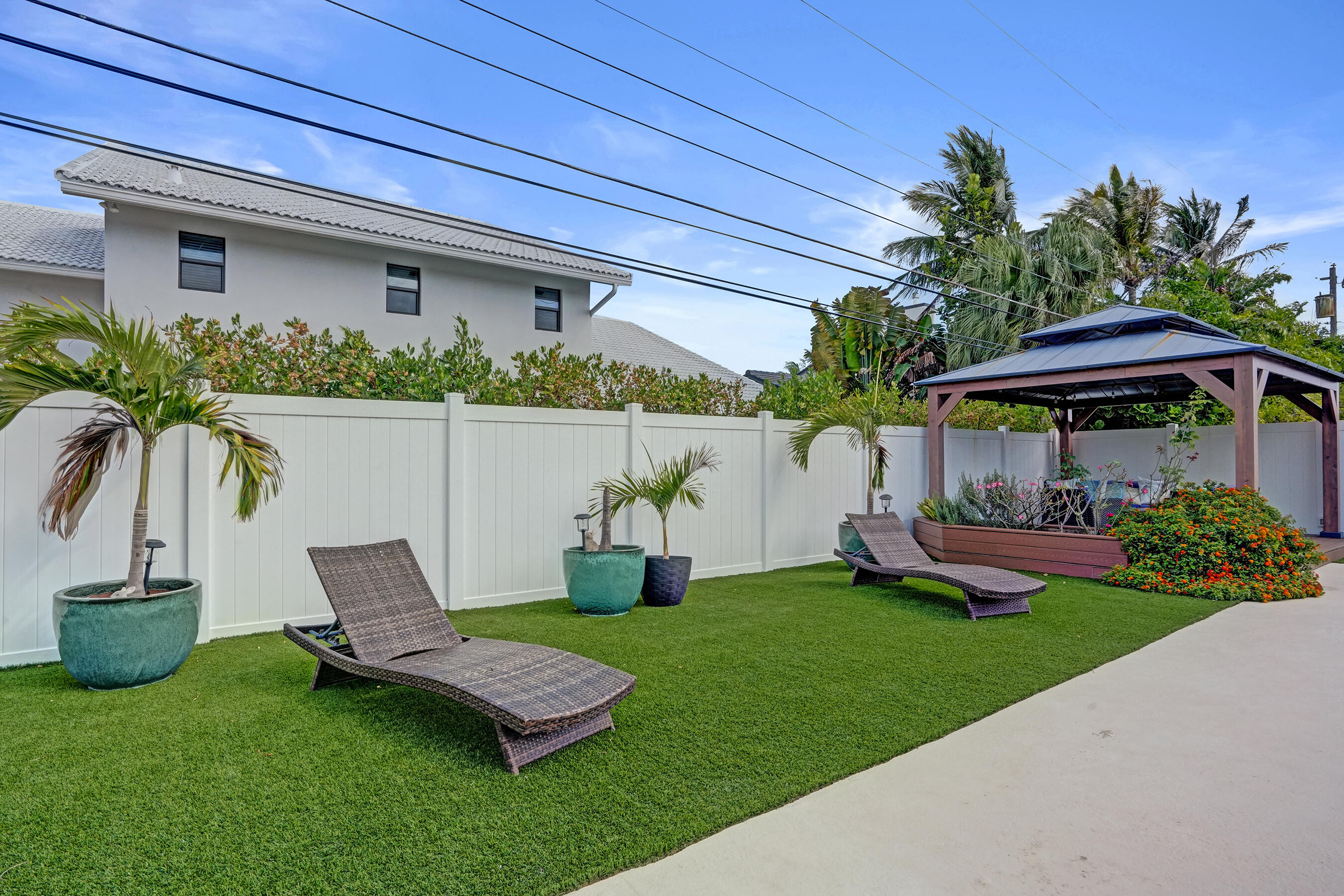 3001 Northeast 45th Street Lighthouse Point, FL 33064 - Photo 64 of 67 a view of a chair and table in backyard of the house