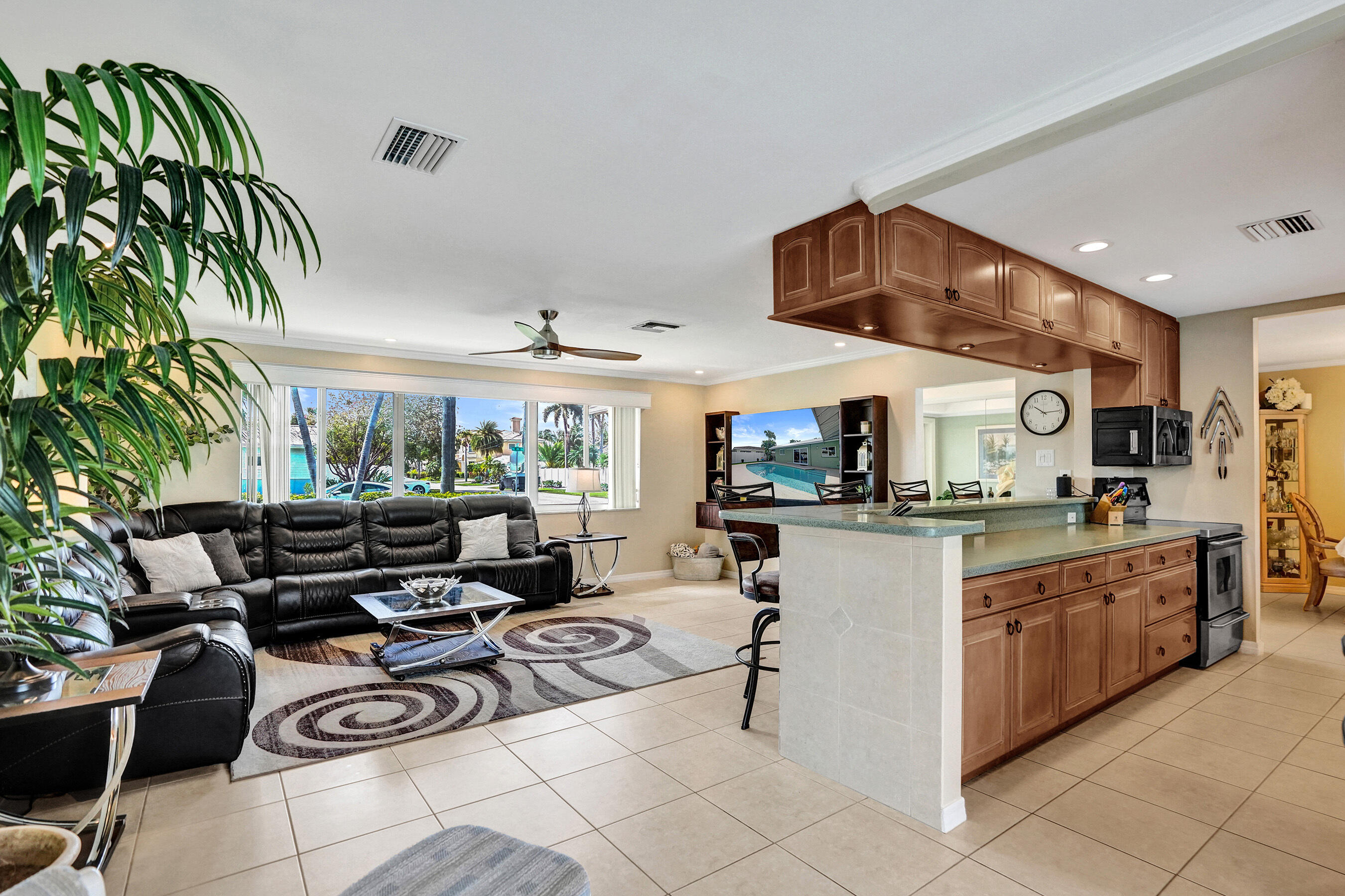 3001 Northeast 45th Street Lighthouse Point, FL 33064 - Photo 9 of 67 a kitchen with stainless steel appliances granite countertop a sink and a stove