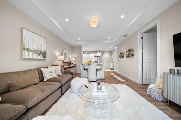a living room with furniture and a wooden floor