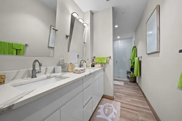 a bathroom with a double vanity sink and a mirror