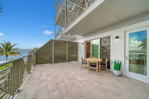 a balcony with furniture and a potted plant