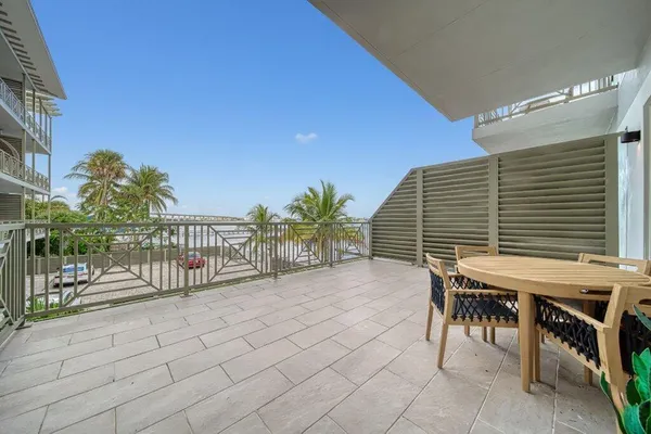 a balcony with table and chairs