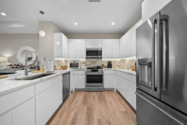 a kitchen with a sink stainless steel appliances and cabinets