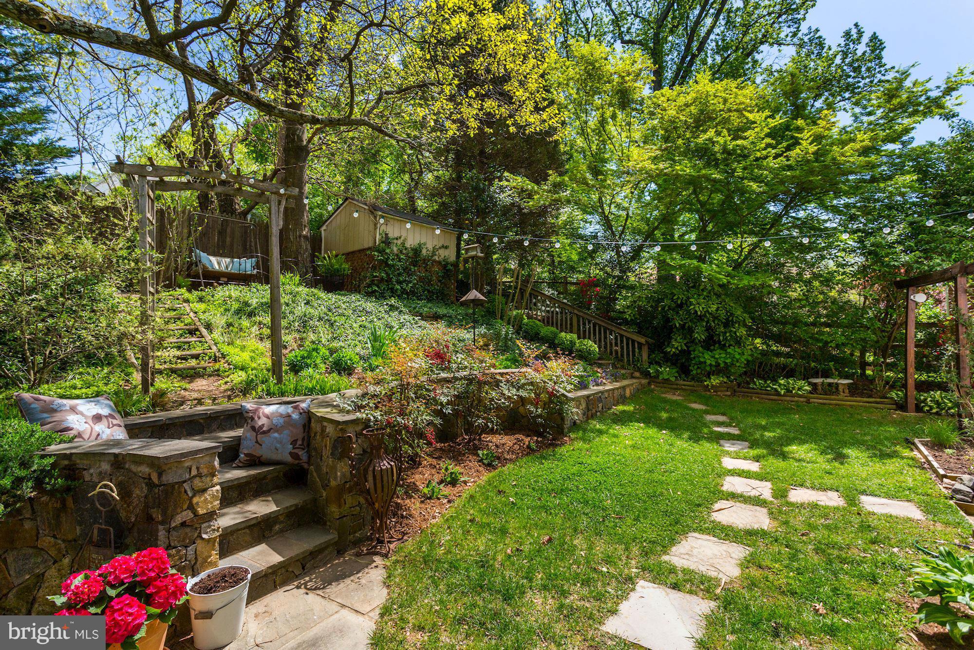 5011 Rodman Road Bethesda, MD 20816 - Photo 22 of 25 a backyard of a house with lots of green space and garden