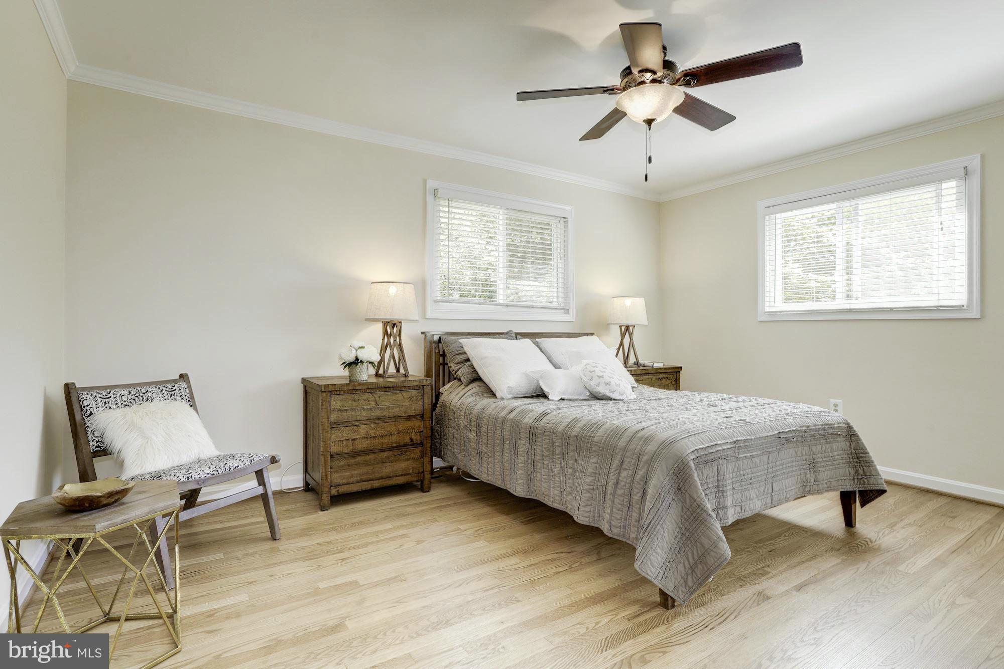 5011 Rodman Road Bethesda, MD 20816 - Photo 7 of 25 a bedroom with a bed and a chandelier