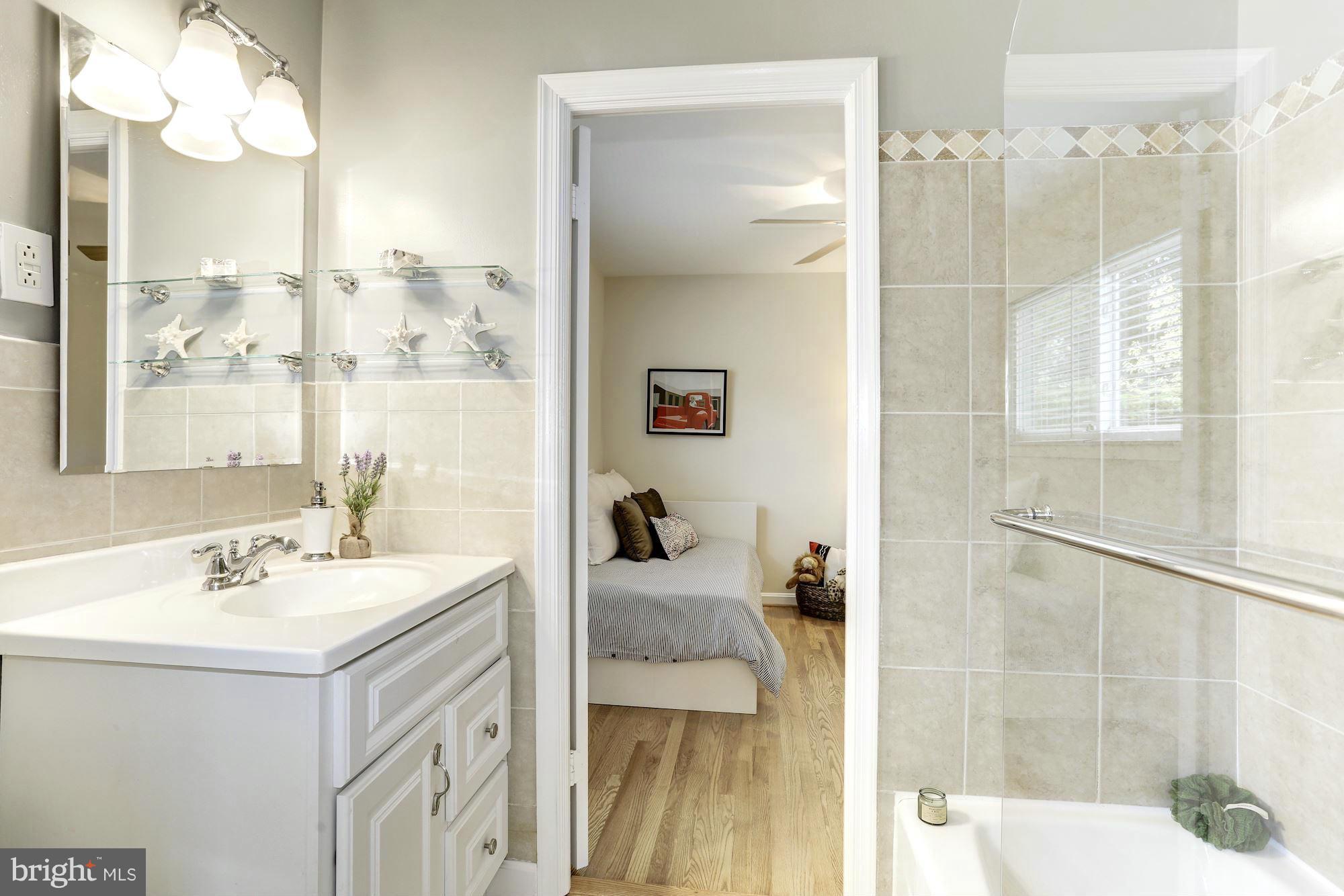 5011 Rodman Road Bethesda, MD 20816 - Photo 10 of 25 a bathroom with a sink vanity tub and shower