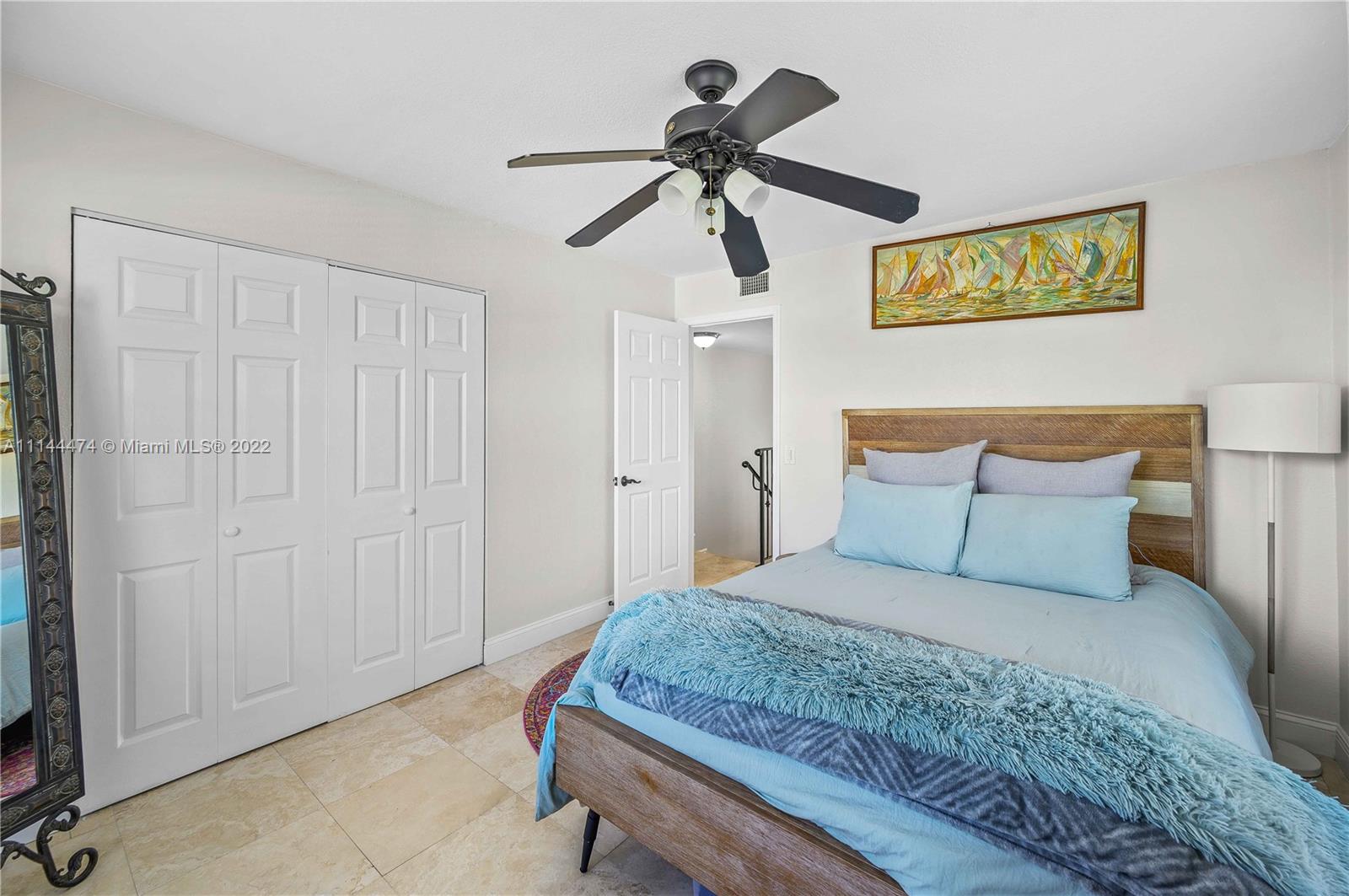 4600 Southwest 67th Avenue, Unit 240 Miami, FL 33155 - Photo 14 of 20 a bedroom with a large bed and a chandelier