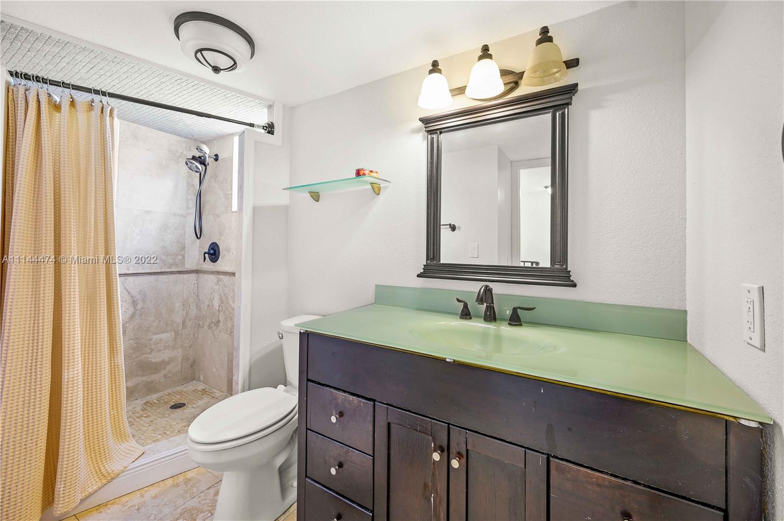 4600 Southwest 67th Avenue, Unit 240 Miami, FL 33155 - Photo 15 of 20 a bathroom with a sink a toilet and shower