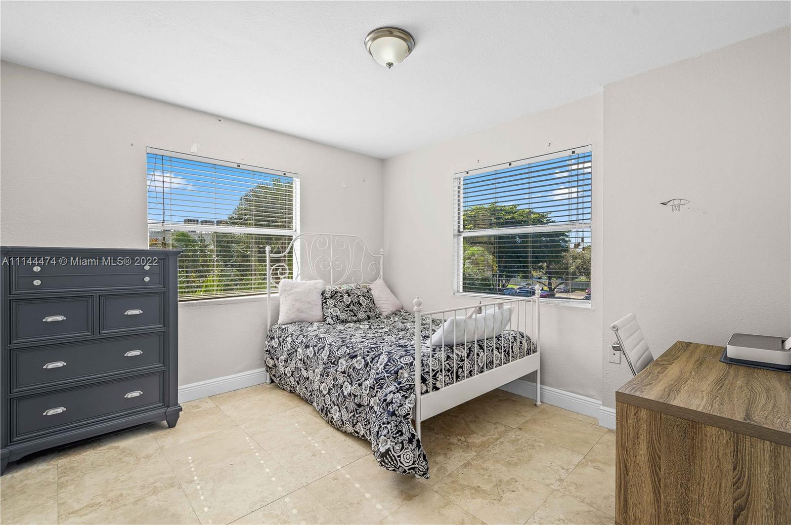 4600 Southwest 67th Avenue, Unit 240 Miami, FL 33155 - Photo 16 of 20 a bed sitting in a bedroom next to a window