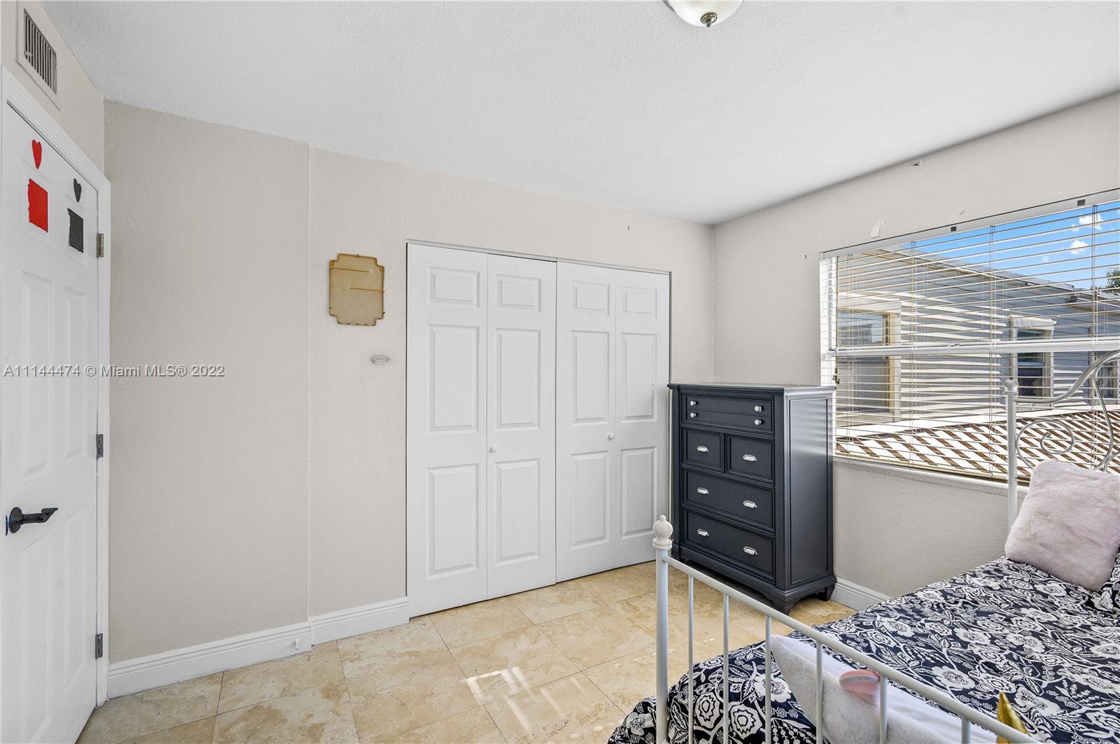4600 Southwest 67th Avenue, Unit 240 Miami, FL 33155 - Photo 17 of 20 a bedroom with a dresser and a window