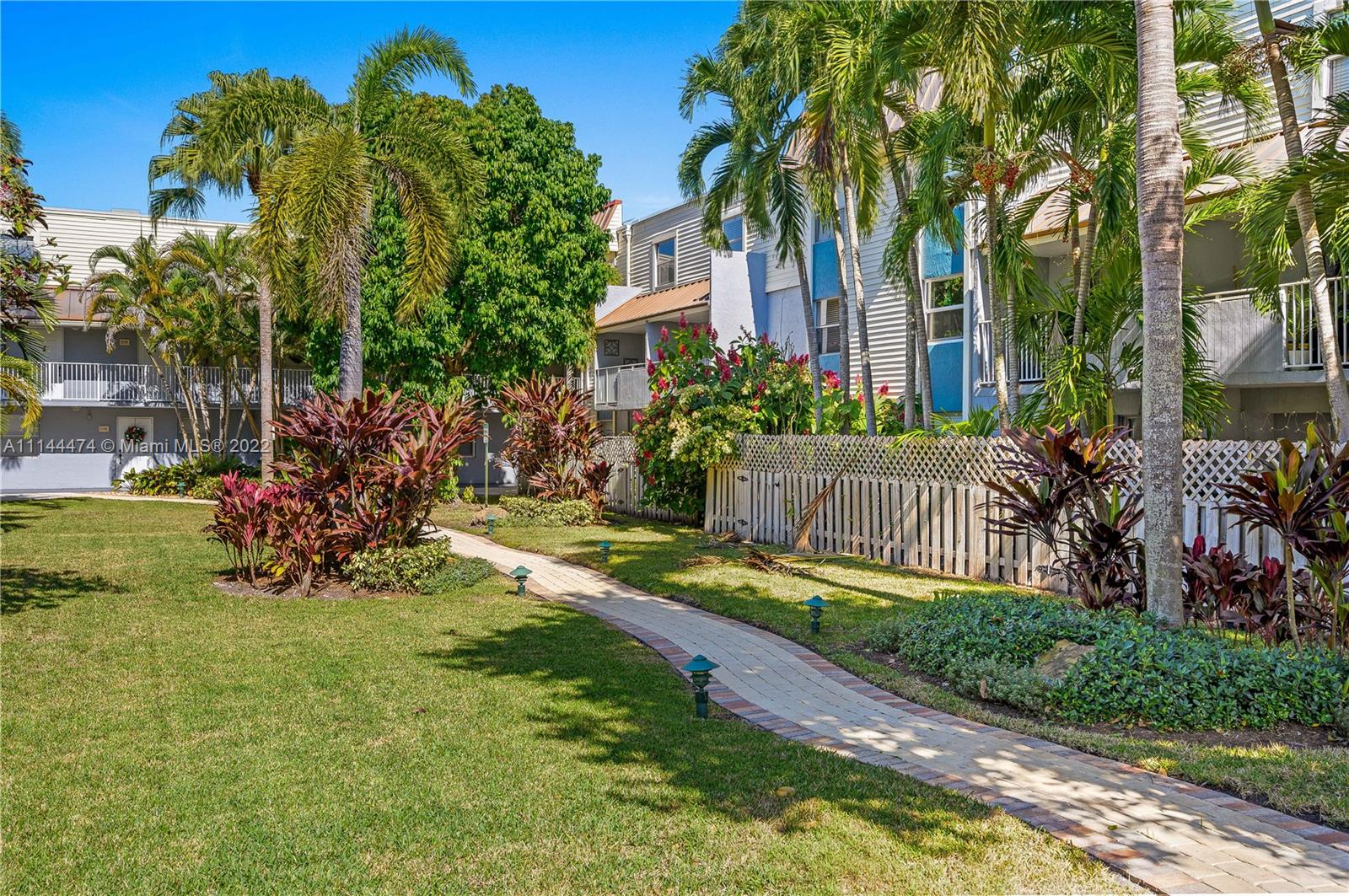 4600 Southwest 67th Avenue, Unit 240 Miami, FL 33155 - Photo 20 of 20 a view of a backyard with plants and palm trees