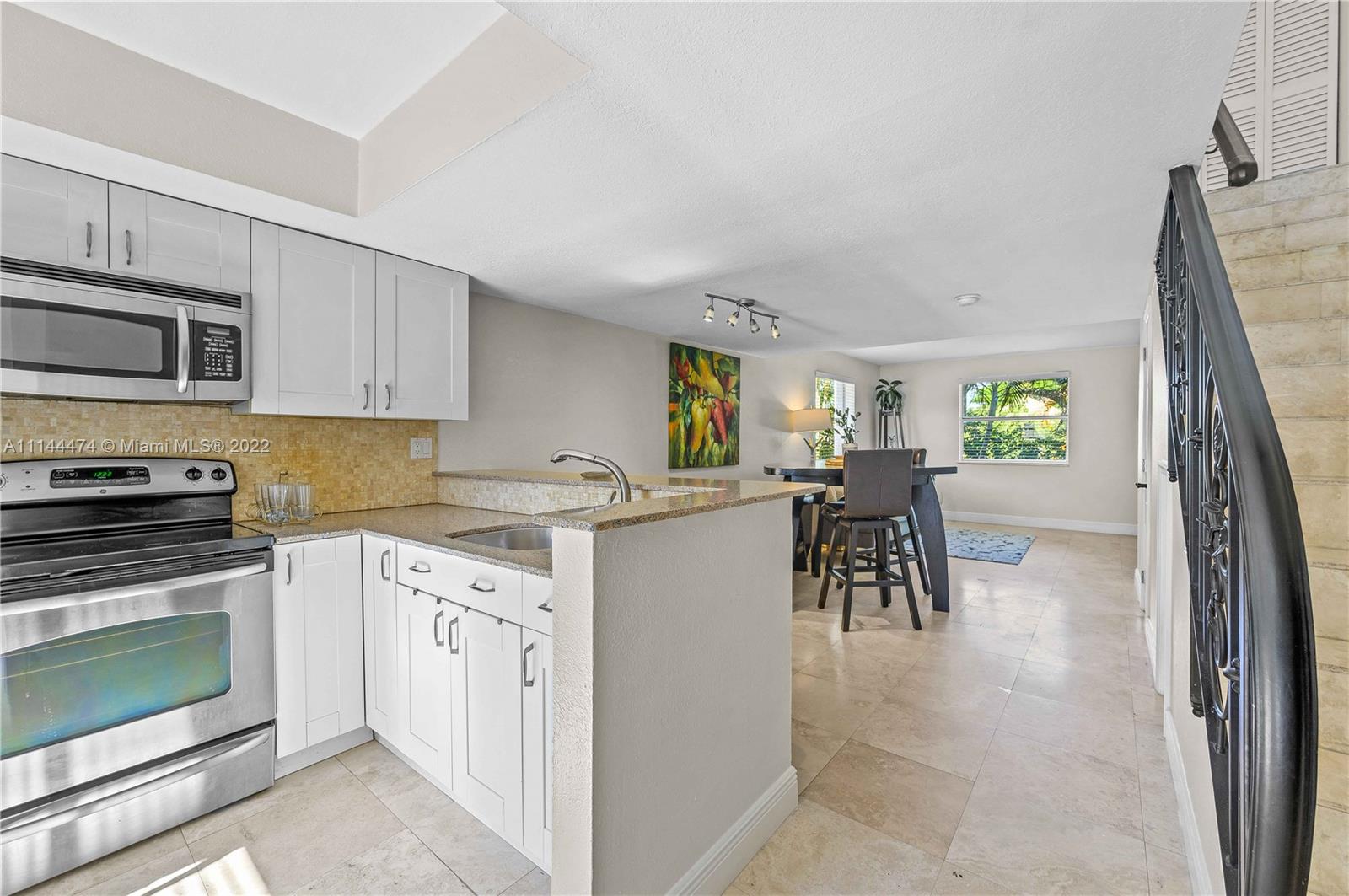 4600 Southwest 67th Avenue, Unit 240 Miami, FL 33155 - Photo 2 of 20 a kitchen with a sink and a stove top oven