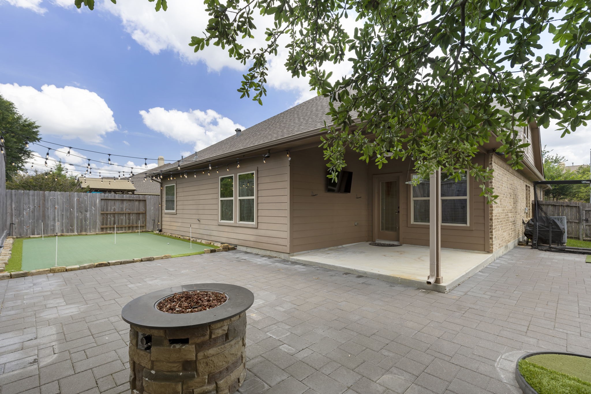 23911 Augusta Falls Lane Spring, TX 77389 - Photo 36 of 40 a view of a backyard with table and chairs and a fire pit