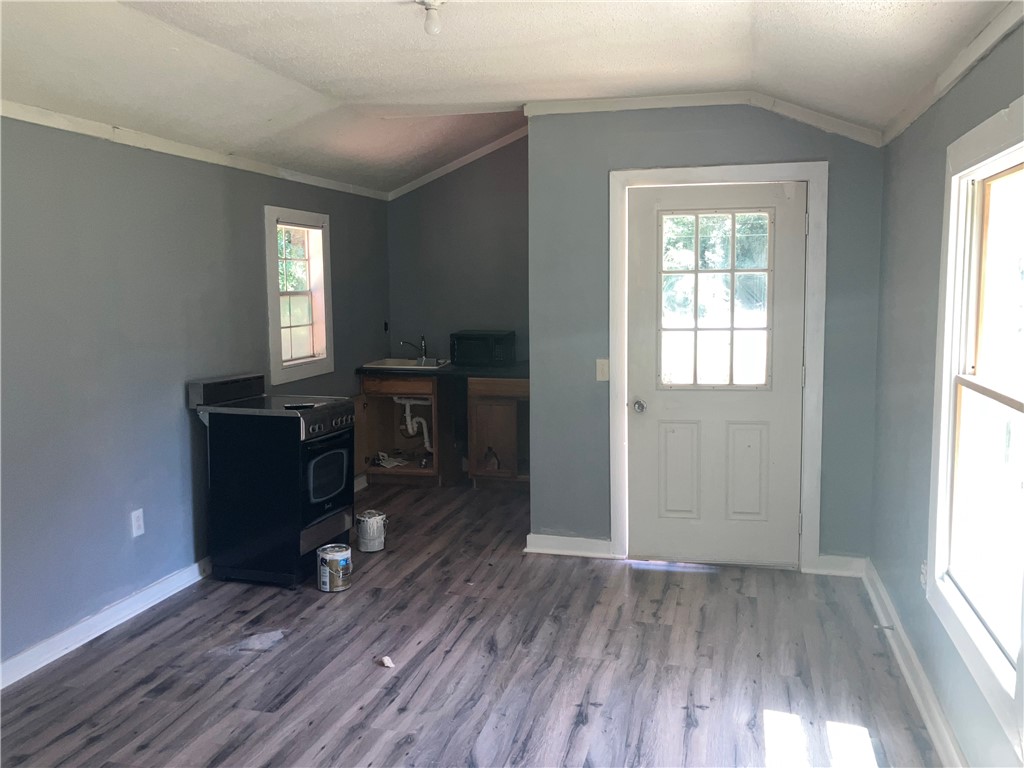 1401 Lebanon Road Pendleton, SC 29670 - Photo 5 of 8 Wood plank flooring and a functional kitchenette offer a flexible living space.