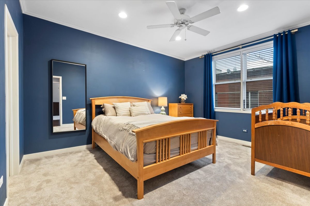 1012 South Loomis Street, Unit D Chicago, IL 60607 - Photo 8 of 17 a bedroom with a bed and window