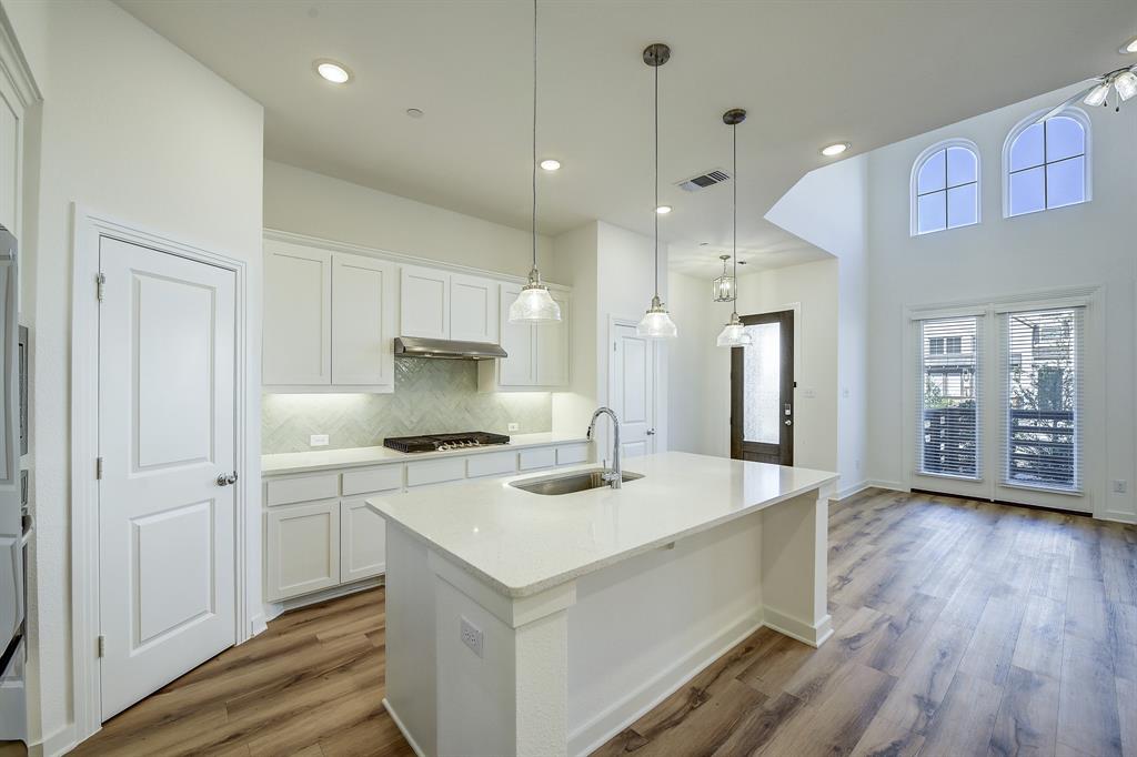3708 Queen Road Sherman, TX 75090 - Photo 18 of 40 a kitchen that has a lot of white cabinets and wooden floor
