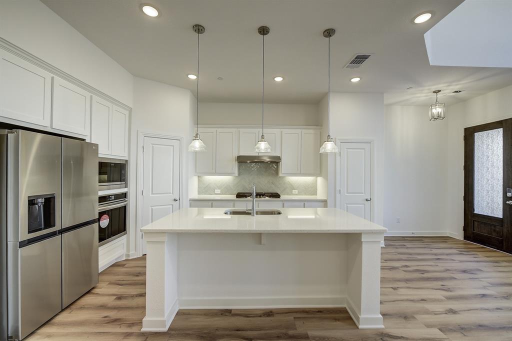 3708 Queen Road Sherman, TX 75090 - Photo 19 of 40 a view of kitchen with kitchen island white cabinets and stainless steel appliances