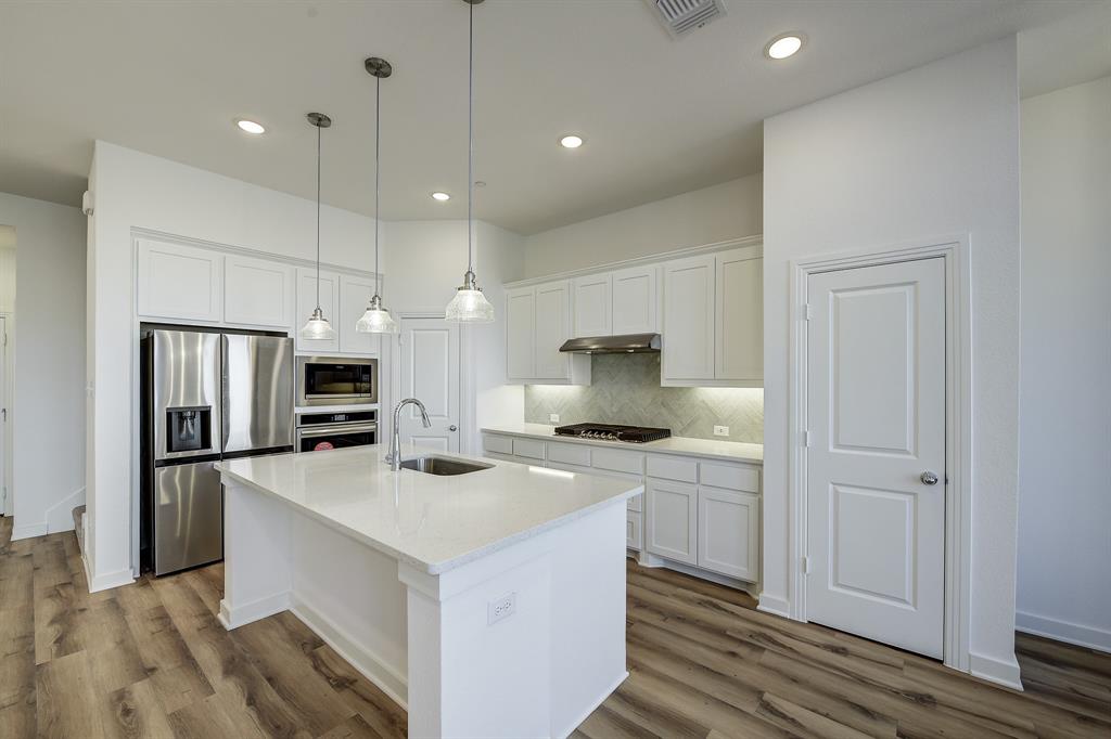3708 Queen Road Sherman, TX 75090 - Photo 20 of 40 a kitchen with a stove a refrigerator and a sink