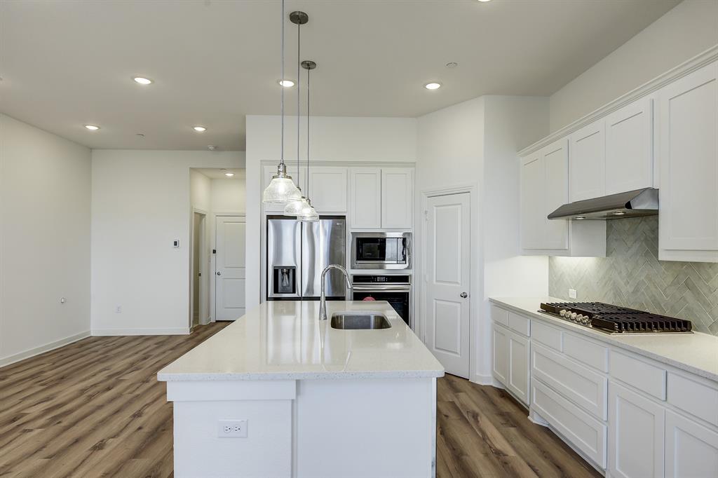 3708 Queen Road Sherman, TX 75090 - Photo 22 of 40 a kitchen with kitchen island a stove a sink and a refrigerator