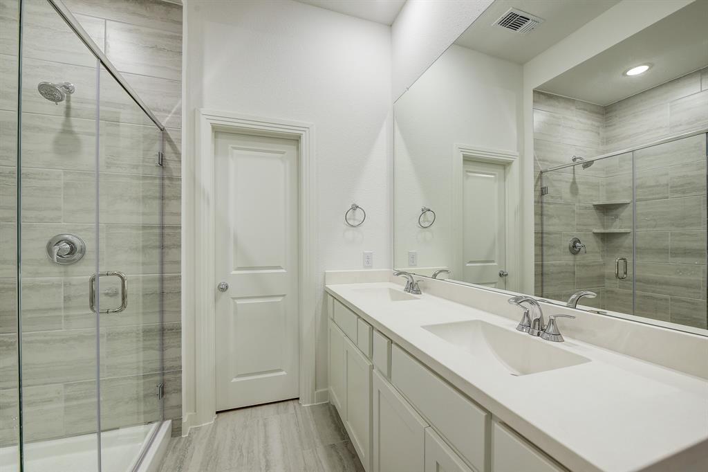 3708 Queen Road Sherman, TX 75090 - Photo 34 of 40 a bathroom with a double vanity sink mirror and shower