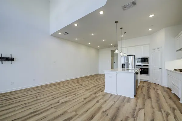 a view of kitchen with cabinets and wooden floor
