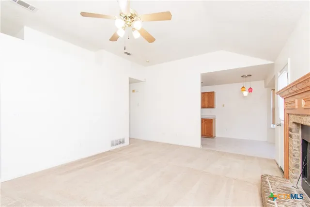 a view of an empty room with a fireplace