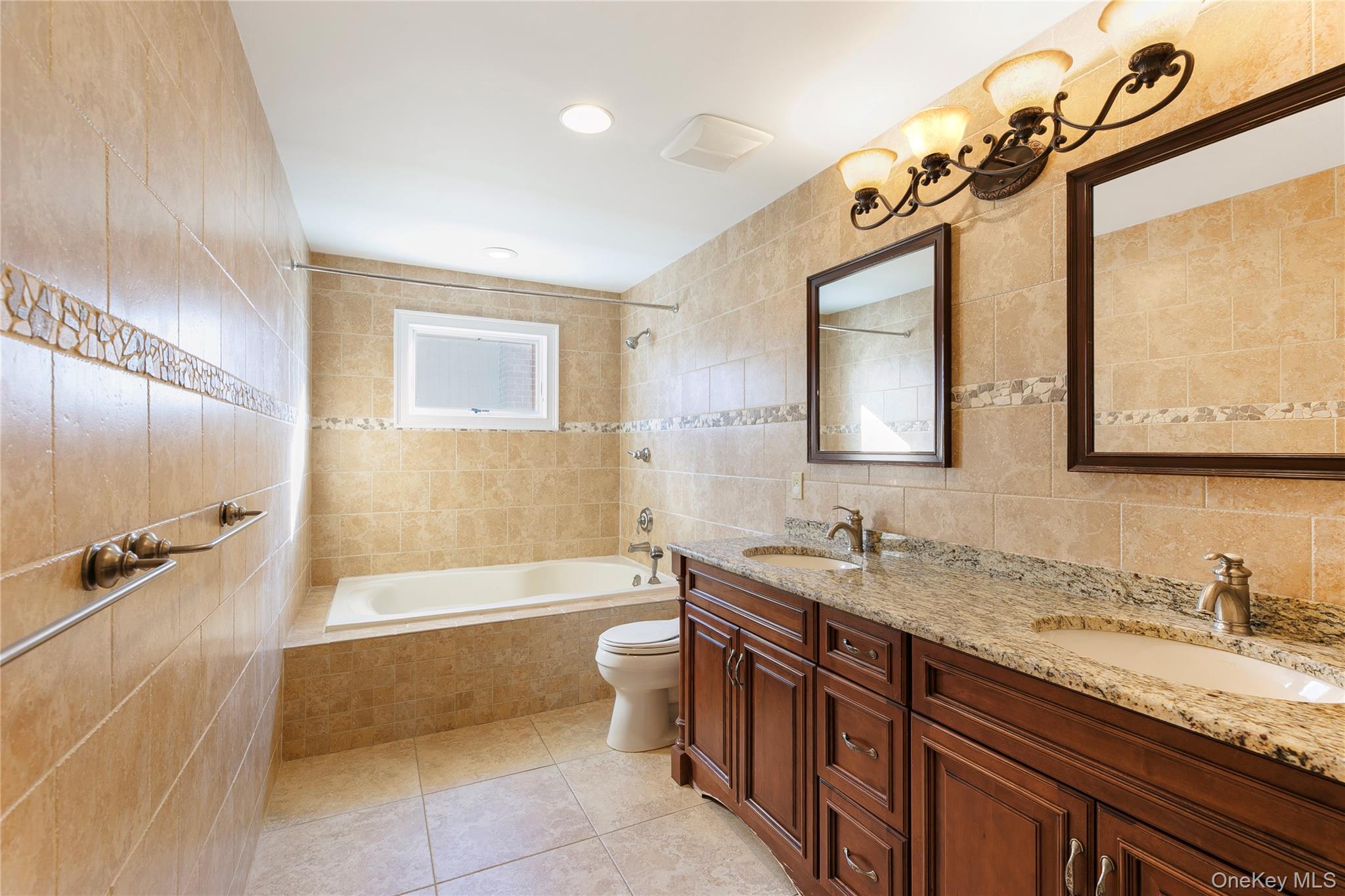 2904 Riverside Drive Wantagh, NY 11793 - Photo 13 of 19 a bath room with a sink and a mirror