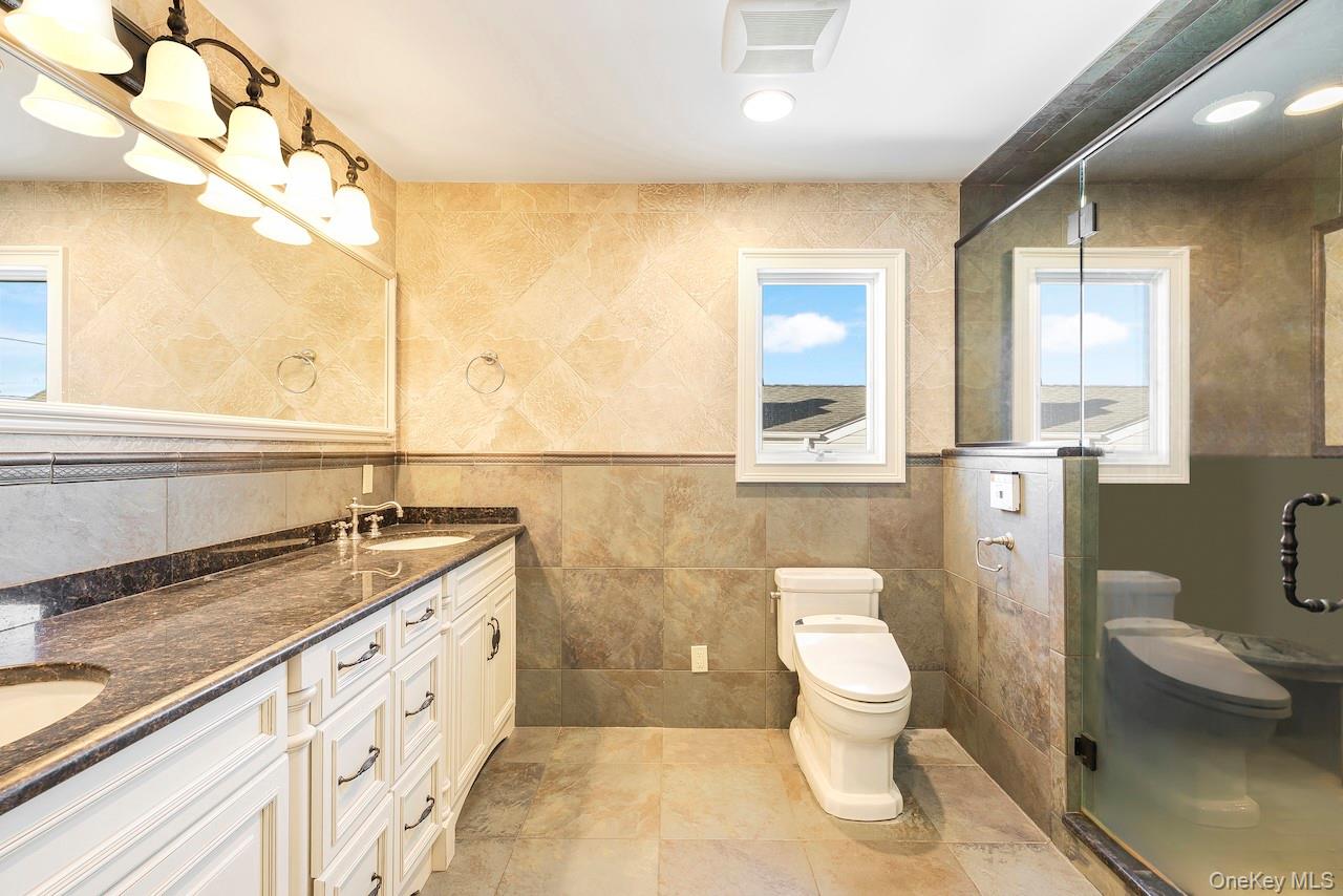 2904 Riverside Drive Wantagh, NY 11793 - Photo 15 of 19 a bathroom with a granite countertop sink toilet and shower