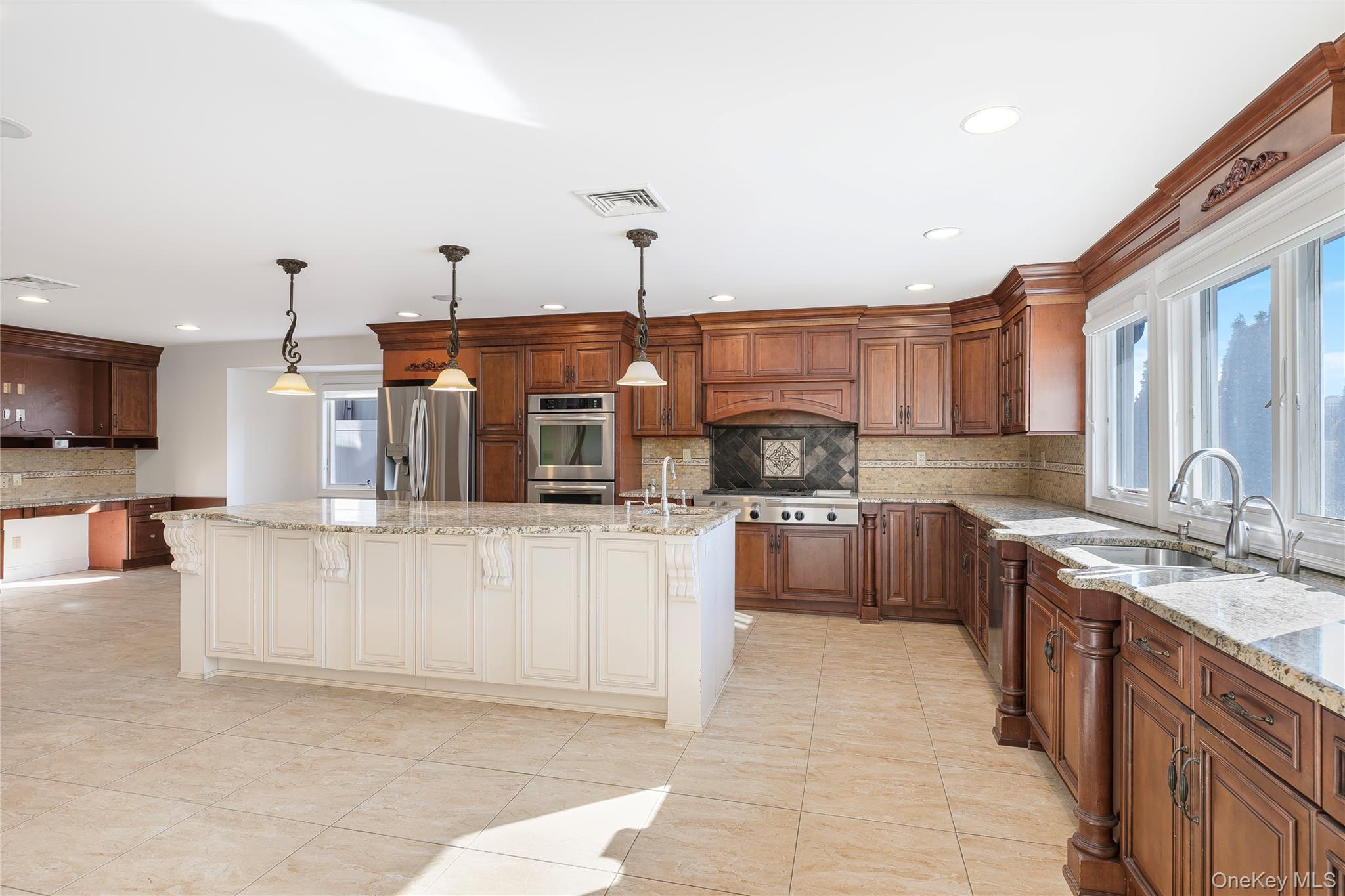 2904 Riverside Drive Wantagh, NY 11793 - Photo 7 of 19 a kitchen with stainless steel appliances kitchen island granite countertop a sink a stove top oven a counter space and cabinets