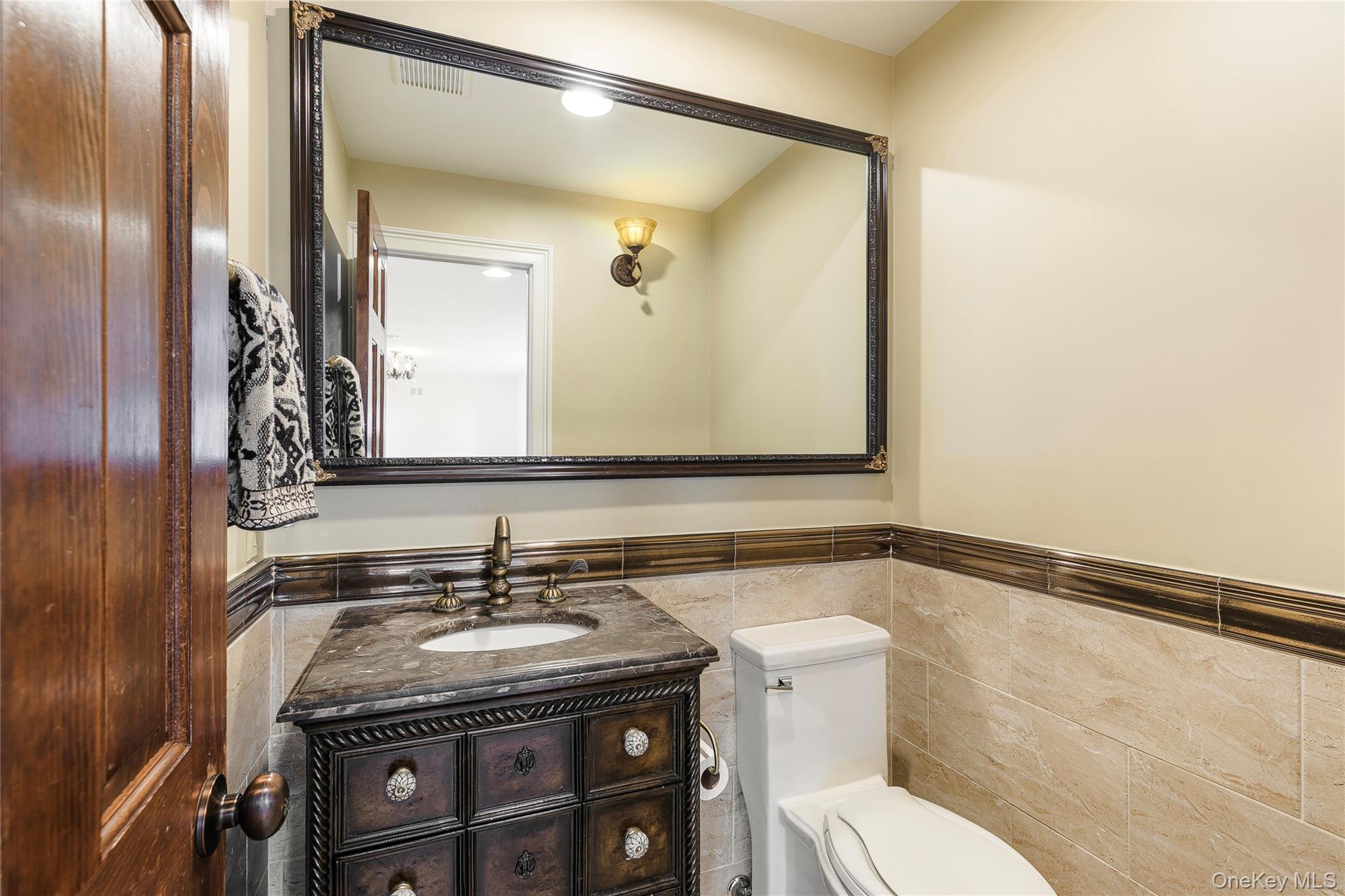 2904 Riverside Drive Wantagh, NY 11793 - Photo 9 of 19 a bathroom with a granite countertop sink toilet and mirror