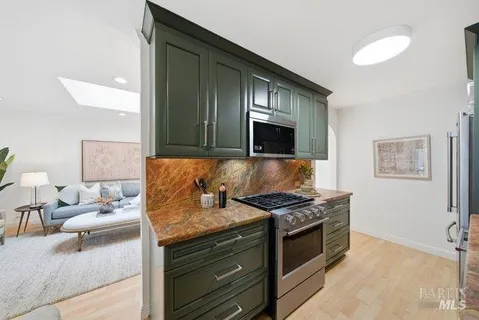 a kitchen with stainless steel appliances granite countertop a stove and a sink