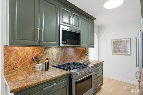 a kitchen with granite countertop a stove and a sink