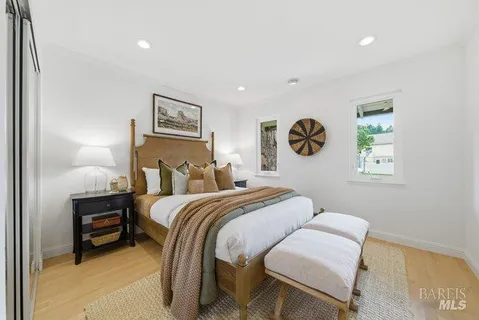 a bedroom with bed and a painting