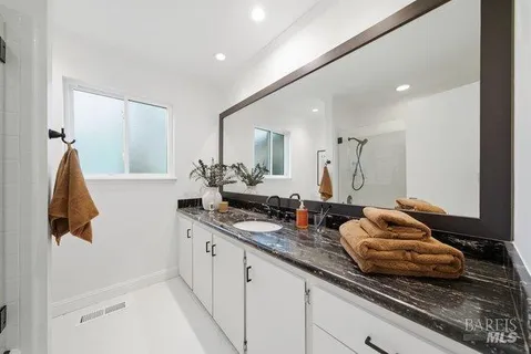 a bathroom with a sink and mirror