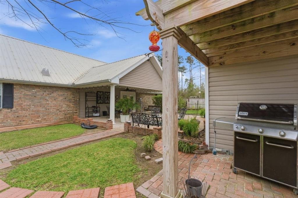 1304 Theriot Road Lake Charles, LA 70611 - Photo 29 of 35 Exterior Back of home showing covered patio and corner of workshop. Covered area for storage or BBQ