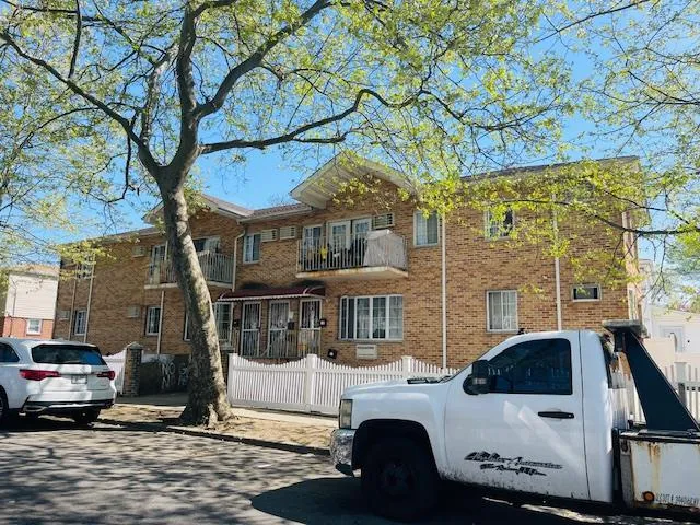 a view of a patio with table and chairs under an umbrella