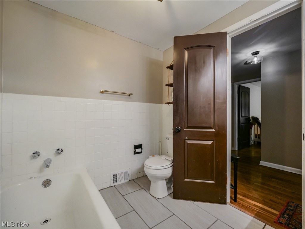 2378 Charney Road Cleveland, OH 44118 - Photo 20 of 28 Bathroom with hardwood / wood-style flooring, toilet, and tile walls