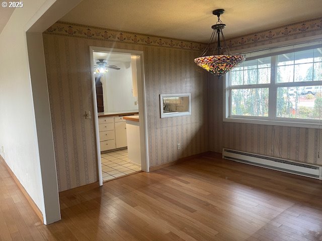 2620 North 23rd Street Springfield, OR 97477 - Photo 11 of 24 an empty room with wooden floor chandelier and windows