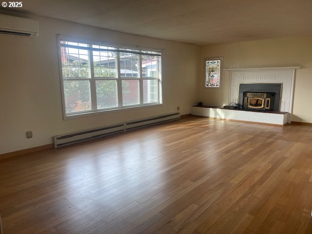 2620 North 23rd Street Springfield, OR 97477 - Photo 12 of 24 an empty room with wooden floor and a fireplace