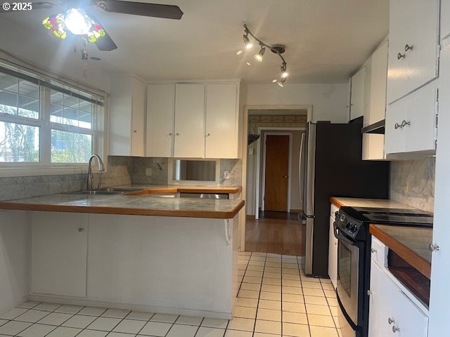 2620 North 23rd Street Springfield, OR 97477 - Photo 9 of 24 a kitchen with kitchen island granite countertop a sink cabinets and stainless steel appliances
