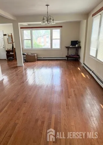 wooden floor chandelier and windows in a room
