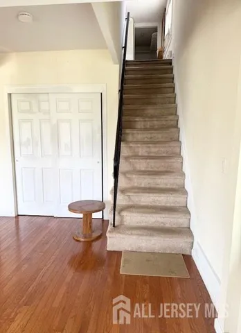 a view of entryway and hall with wooden floor