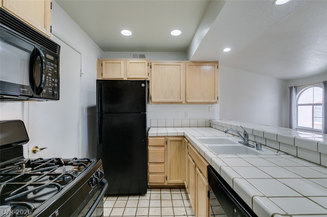 7570 West Flamingo Road, Unit 252 Las Vegas, NV 89147 - Photo 24 of 44 Functional kitchen with ample counter space and appliances, ready for culinary endeavors.