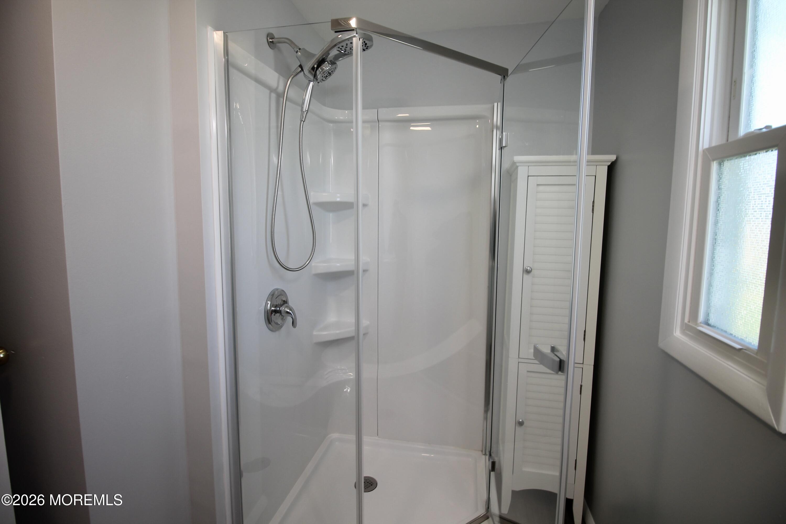 623 Sara Drive Freehold, NJ 07728 - Photo 19 of 28 a bathroom with a glass shower door